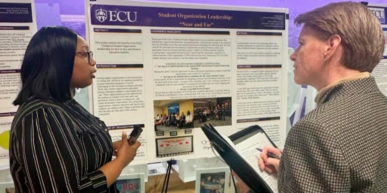 HHP interim dean Dr. Stacey Altman listens to Angelica Jones, a student organization leadership category winner at the inaugural HHP Experiential Learning Expo event.