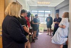 Students and HHP administrators socialize in the dean's office of the Rivers Building. 