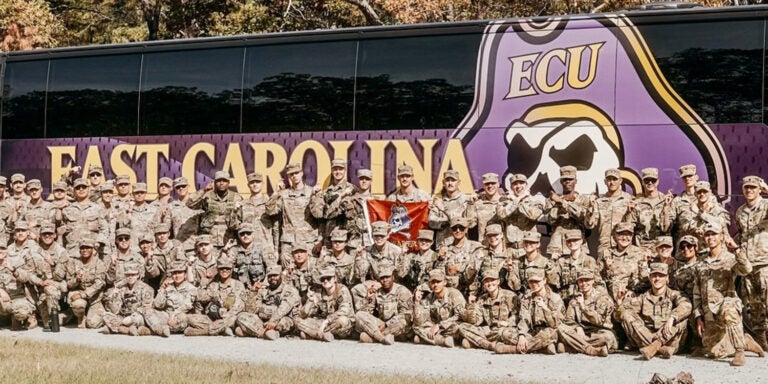 ECU Army ROTC cadets in front of ECU bus.