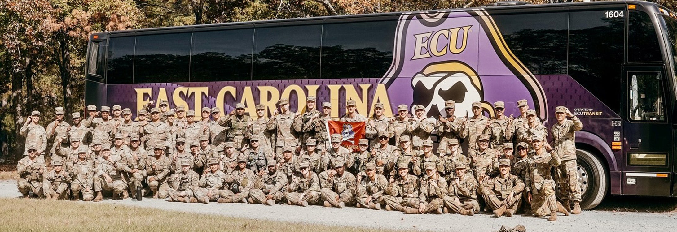 ECU Army ROTC cadets in front of ECU bus.