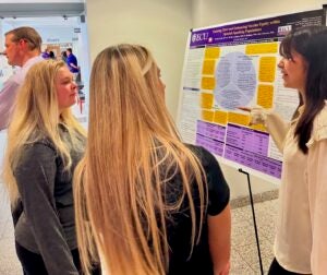 Students in Rivers Building at ECU discuss an experiential learning project. 