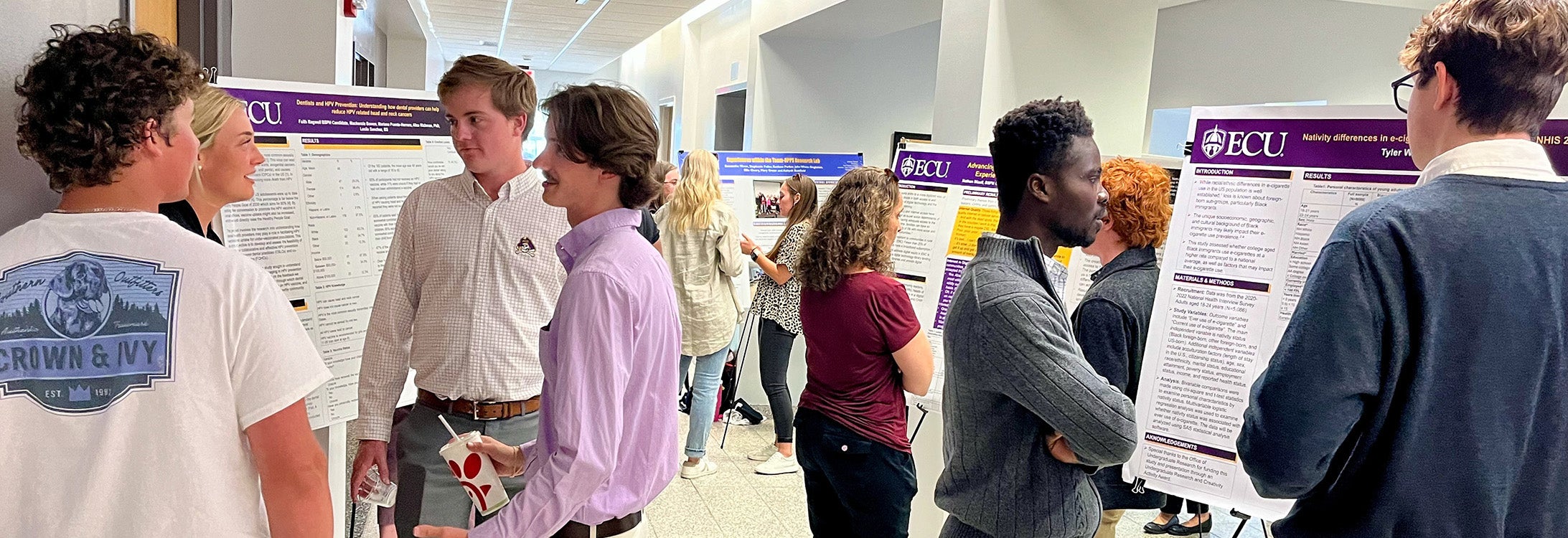 Students and faculty members talk about experiential learning in the Rivers Building at HHP's inaugural Experiential Learning Expo event.