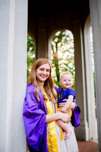 Tori Du Sablon, who earned her Bachelor of Science in biochemistry degree in May as the first COMPASS participant graduate, with child at ECU Cupola.