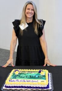 Dr. Jennifer Hodgson stands with her cake at the event.