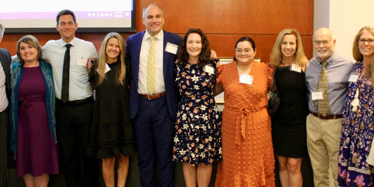 Leaders of the ECU marriage and family therapy and medical family therapy anniversary celebration gather in Harvey Hall for a photo.