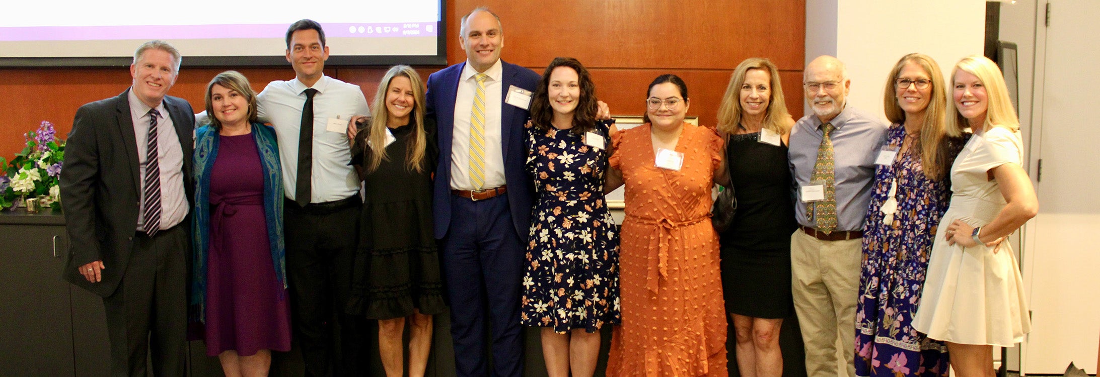 Leaders of the ECU marriage and family therapy and medical family therapy anniversary celebration gather in Harvey Hall for a photo.