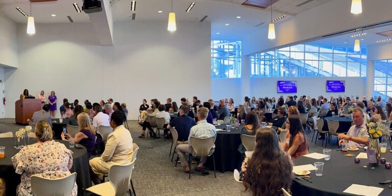 Two-time ECU School of Social Work alum Kashayia Coltrane speaks to attendees at the 2024-25 ECU HHP Scholarship social event.