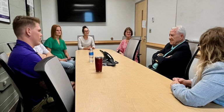 Dr. Jerry McGee smiles as he talks with students in the Belk Building on Sept. 27, 2024.