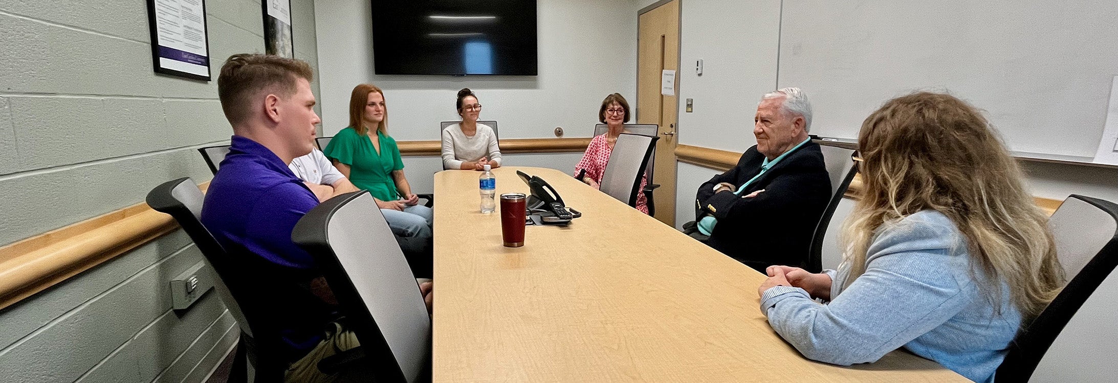 Dr. Jerry McGee smiles as he talks with students in the Belk Building on Sept. 27, 2024.