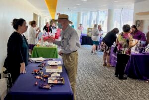 Dr. Abby Schwartz, left, talks to a visitor about the Office of Healthy Aging at the Alzheimer’s and dementia resource fair. 