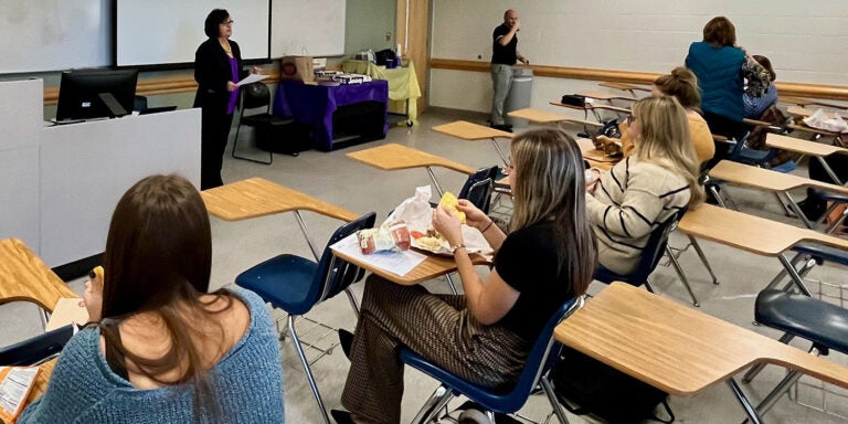 Students in HLTH 4880 listen to teaching instructor Amy Hattem before the start of their mock grant project presentation.