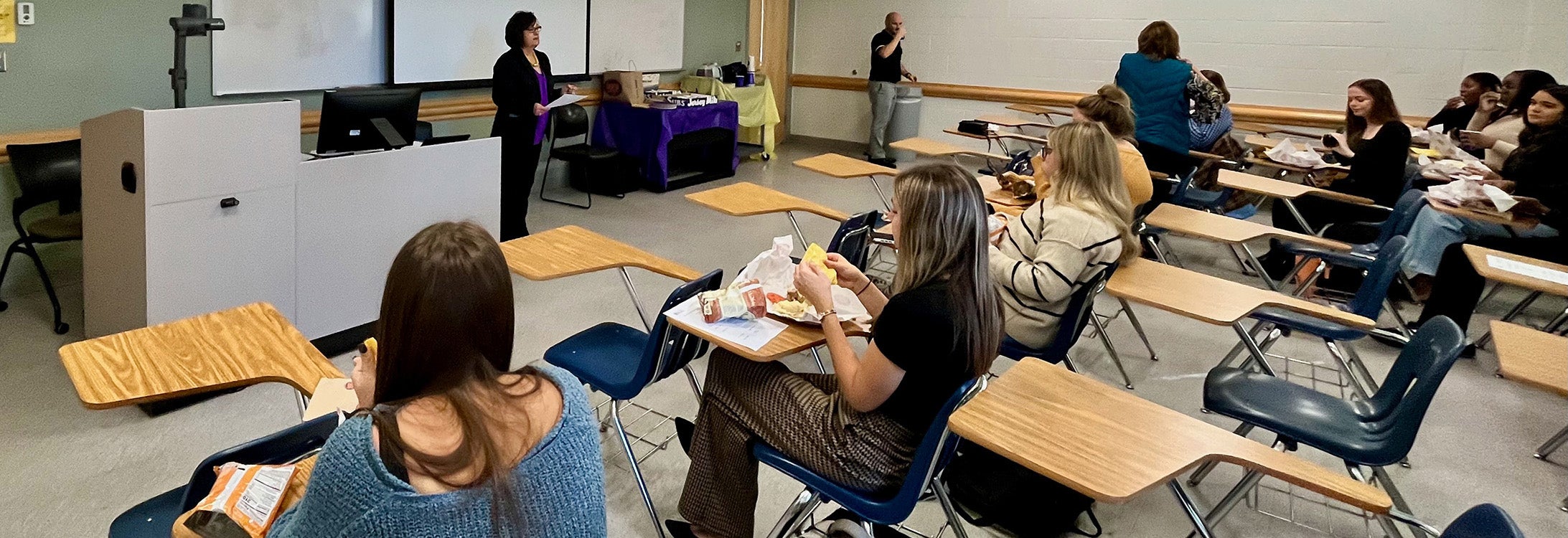 Students in HLTH 4880 listen to teaching instructor Amy Hattem before the start of their mock grant project presentation.