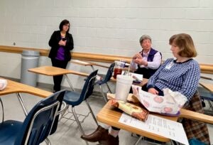 Alice Keene talks in classroom and others listen at their desk.