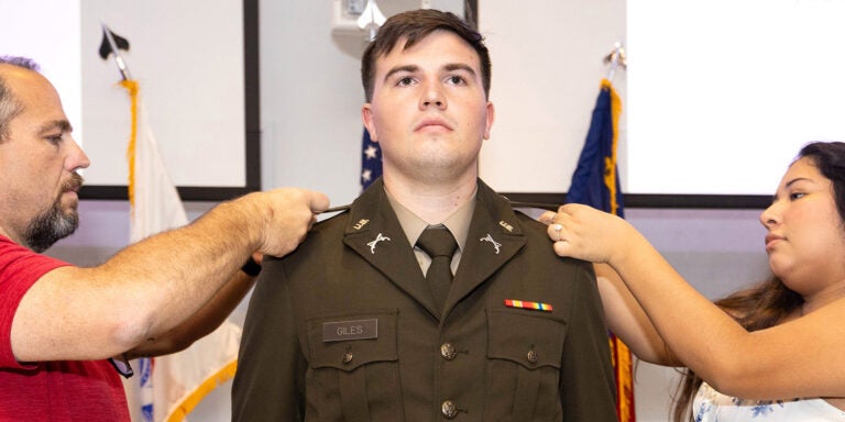 Kody Giles is pinned by family representatives during the East Carolina University Army ROTC Pirate Battalion summer commissioning ceremony Aug. 2, 2024. (ECU Photo by Rhett Butler)