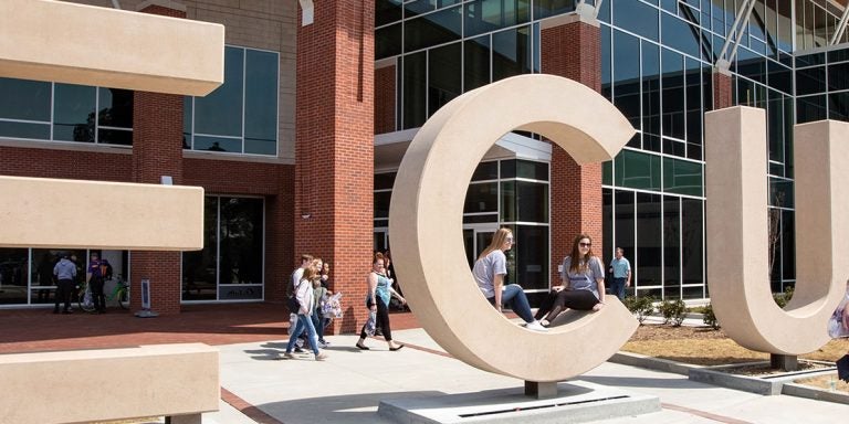 Family and friends take photos of incoming freshmen with the ECU letters at the Main Student Center during Admitted Student Day at ECU on Saturday. (Photo by Rhett Butler)
