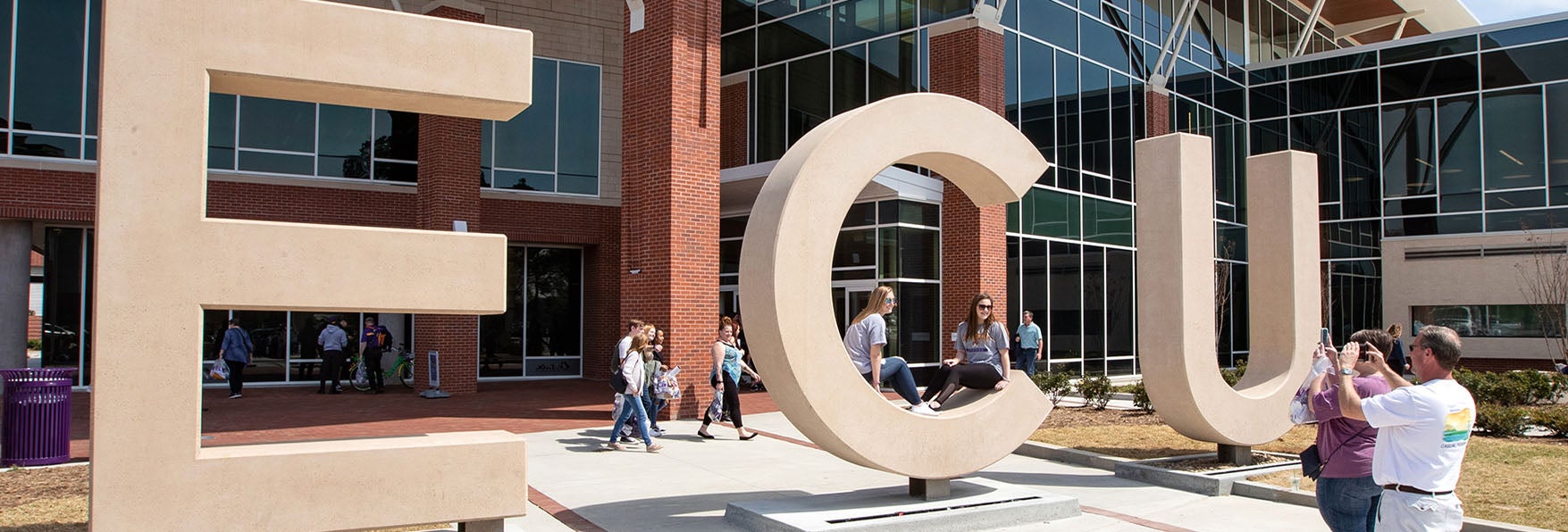 Family and friends take photos of incoming freshmen with the ECU letters at the Main Student Center during Admitted Student Day at ECU on Saturday. (Photo by Rhett Butler)